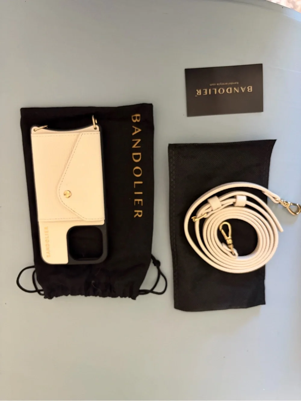 Bandolier White Leather Crossbody Phone Case with Gold Accents and Strap